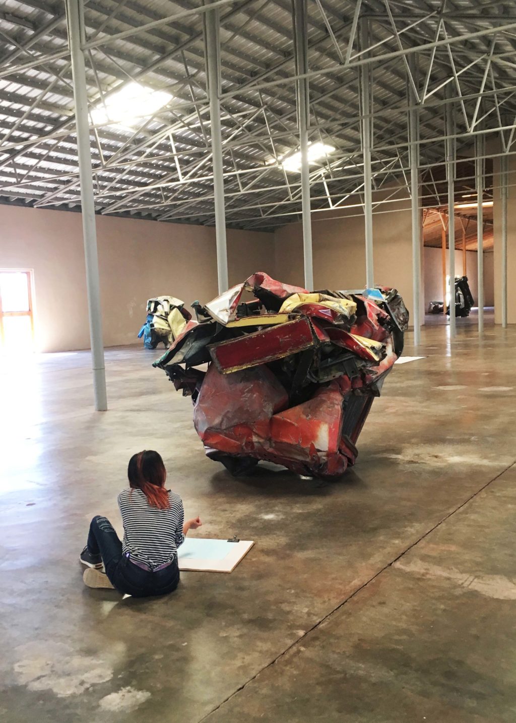 Young artist sketching in the Chamberlain installation